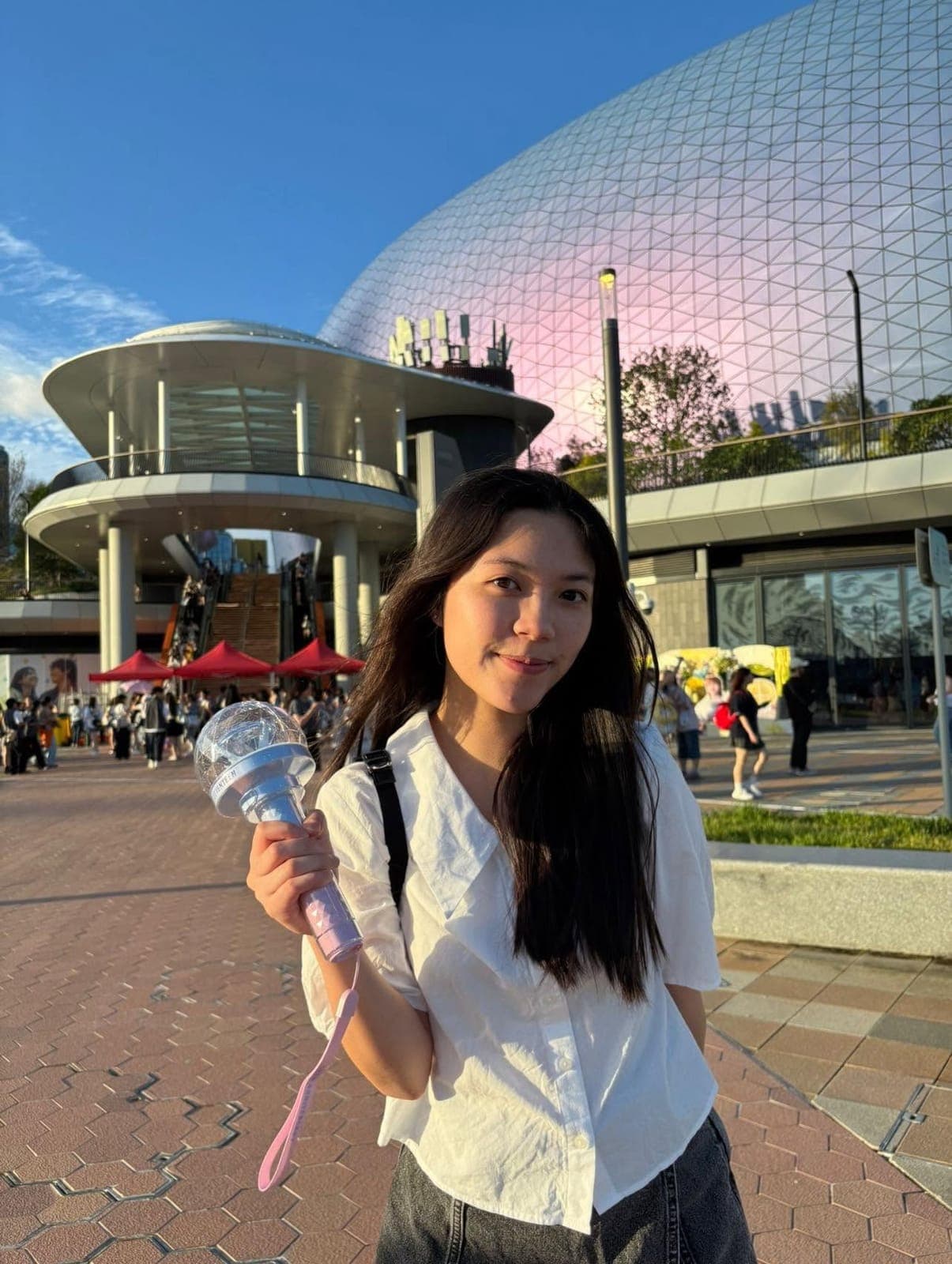 An exchange participant smiling in a city square in the evening